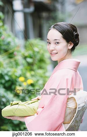 Young Japanese woman in a traditional kimono View Large Photo Image Stock Photograph - Young Japanese woman in a traditional kimono. Fotosearch