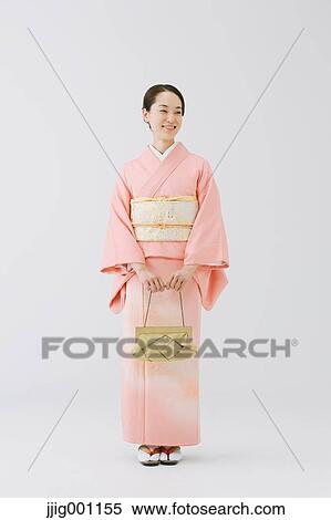 Young Japanese woman in a traditional kimono against white background View Large Photo Image Stock Photography - Young Japanese woman in a traditional kimono against white background. Fotosearch