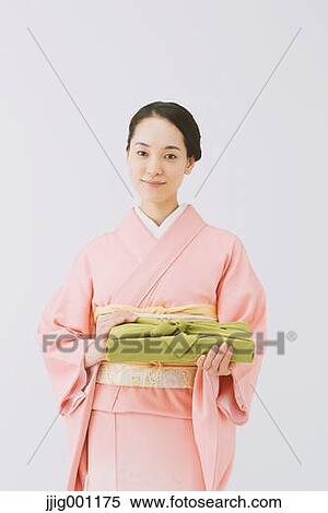 Young Japanese woman in a traditional kimono against white background View Large Photo Image Stock Photography - Young Japanese woman in a traditional kimono against white background. Fotosearch