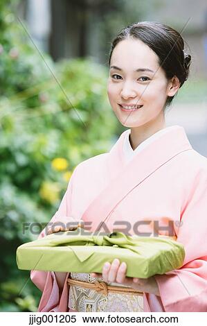 Young Japanese woman in a traditional kimono View Large Photo Image Stock Photography - Young Japanese woman in a traditional kimono. Fotosearch