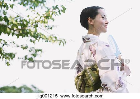 Young Japanese woman in a traditional kimono View Large Photo Image Stock Photography - Young Japanese woman in a traditional kimono. Fotosearch