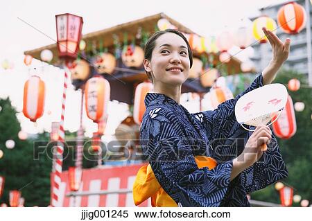 Young Japanese woman in a traditional kimono at a summer festival View Large Photo Image Stock Photography - Young Japanese woman in a traditional kimono at a summer festival. Fotosearch