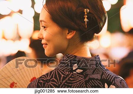 Young Japanese woman in a traditional kimono at a summer festival View Large Photo Image Stock Photography - Young Japanese woman in a traditional kimono at a summer festival. Fotosearch