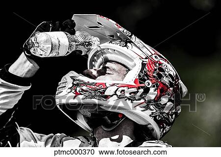 Stock Image - Young Man Relaxing After Riding Dirt Bike. Fotosearch