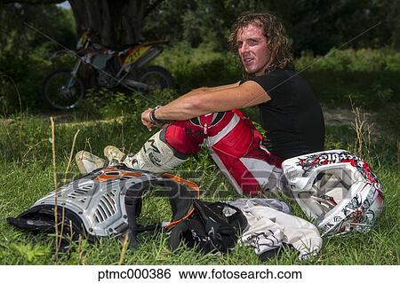 Young Man Relaxing After Riding Dirt Bike View Large Photo Image Stock Photograph - Young Man Relaxing After Riding Dirt Bike. Fotosearch