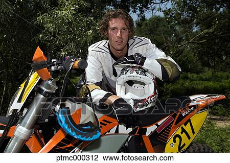 Young Man Relaxing Besides Motocross Bike in Countryside View Large Photo Image Stock Image - Young Man Relaxing Besides Motocross Bike in Countryside. Fotosearch