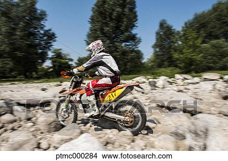 Picture - Young Man Riding Motocross Bike in Italian Countryside. Fotosearch