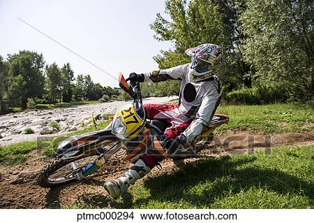 Picture - Young Man Riding Motocross Bike in Italian Countryside. Fotosearch