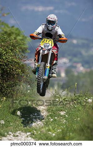 Picture - Young Man Riding Motocross Bike in Italian Countryside. Fotosearch