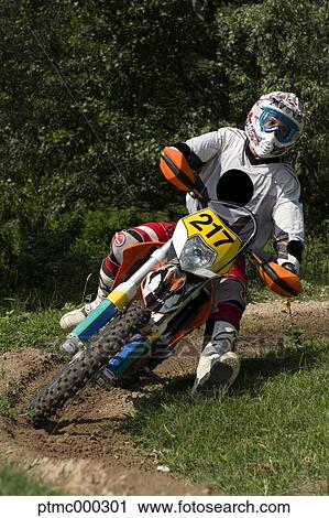 Stock Image - Young Man Riding Motocross Bike in Italian Countryside. Fotosearch