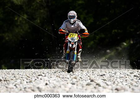 Stock Image - Young Man Riding Motocross Bike in Italian Countryside. Fotosearch