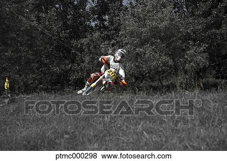Stock Photo - Young Man Riding Motocross Bike in Italian Countryside. Fotosearch