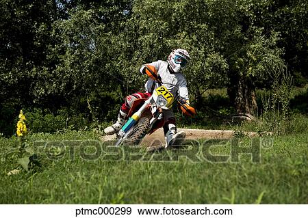 Stock Photo - Young Man Riding Motocross Bike in Italian Countryside. Fotosearch