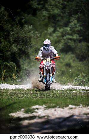 Stock Photo - Young Man Riding Motocross Bike in Italian Countryside. Fotosearch