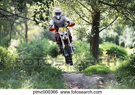 Stock Photograph - Young Man Riding Motocross Bike in Italian Countryside. Fotosearch
