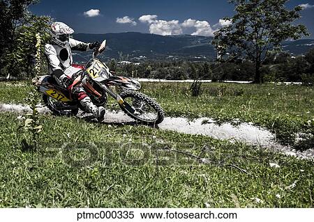 Stock Photography - Young Man Riding Motocross Bike in Italian Countryside. Fotosearch