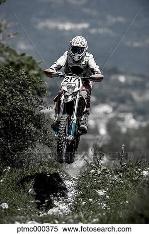 Stock Photography - Young Man Riding Motocross Bike in Italian Countryside. Fotosearch