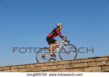 Picture - Young Japanese girl cycling. Fotosearch
