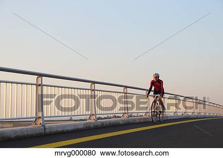 Stock Image - Young Japanese girl cycling. Fotosearch