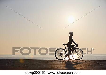 Stock Image - Young Japanese girl cycling. Fotosearch