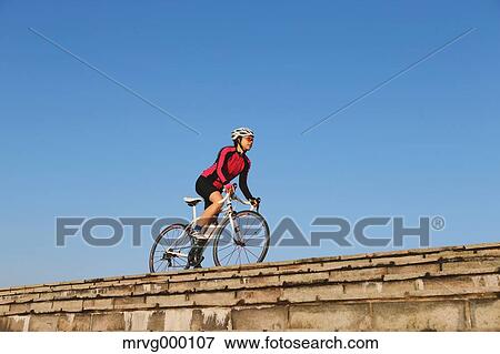 Stock Photo - Young Japanese girl cycling. Fotosearch