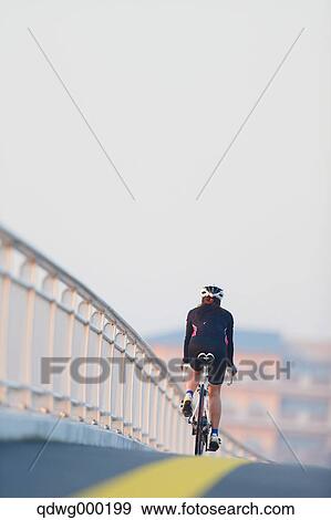 Stock Photo - Young Japanese girl cycling. Fotosearch