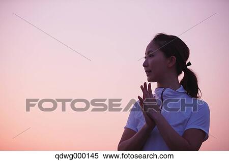 Stock Photography - Young Japanese girl in fitness clothes looking away. Fotosearch