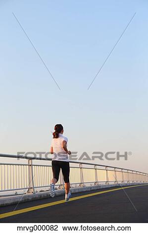 Stock Image - Young Japanese girl jogging. Fotosearch