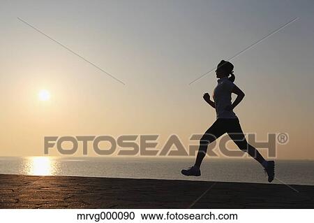 Stock Image - Young Japanese girl jogging. Fotosearch