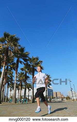 Stock Image - Young Japanese girl jogging. Fotosearch
