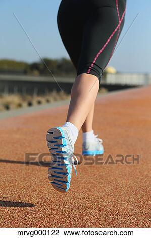 Stock Image - Young Japanese girl jogging. Fotosearch