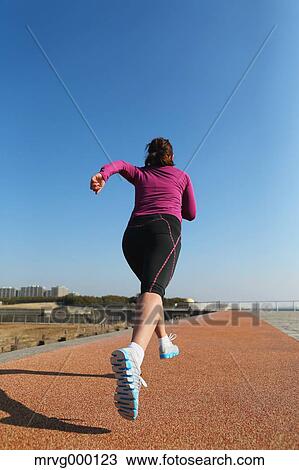 Young Japanese girl jogging View Large Photo Image Stock Image - Young Japanese girl jogging. Fotosearch