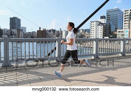 Stock Image - Young Japanese girl jogging. Fotosearch