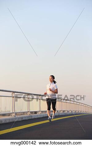 Stock Image - Young Japanese girl jogging. Fotosearch
