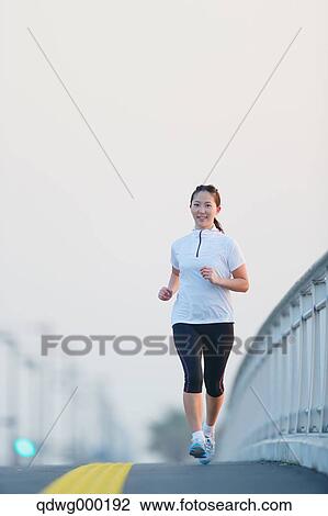 Stock Image - Young Japanese girl jogging. Fotosearch