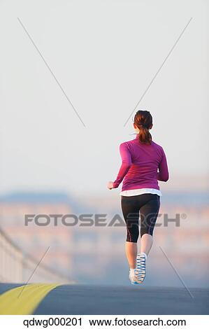 Stock Image - Young Japanese girl jogging. Fotosearch