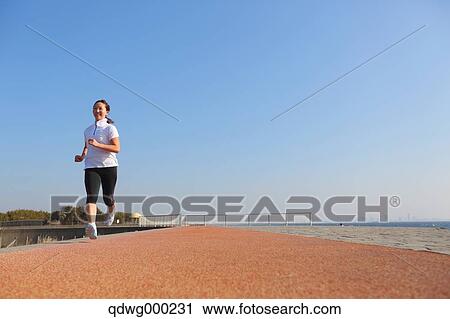 Stock Image - Young Japanese girl jogging. Fotosearch