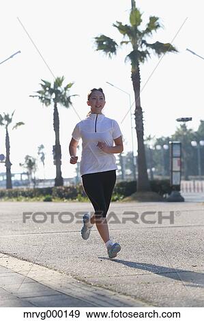 Stock Photo - Young Japanese girl jogging. Fotosearch