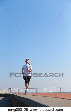 Young Japanese girl jogging View Large Photo Image Stock Photograph - Young Japanese girl jogging. Fotosearch
