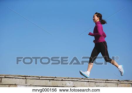 Stock Photograph - Young Japanese girl jogging. Fotosearch
