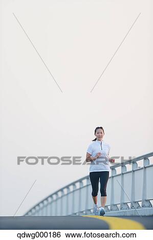 Young Japanese girl jogging View Large Photo Image Stock Photograph - Young Japanese girl jogging. Fotosearch