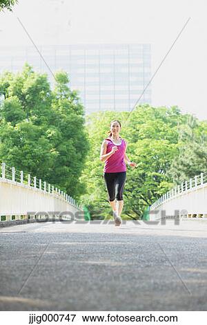 Stock Photo - Young Japanese girl running in the park. Fotosearch