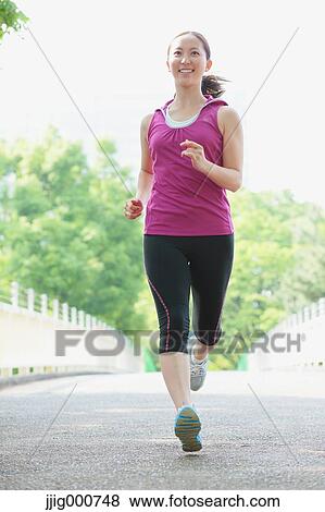 Young Japanese girl running in the park View Large Photo Image Stock Photo - Young Japanese girl running in the park. Fotosearch