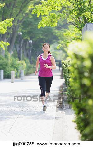 Young Japanese girl running in the park View Large Photo Image Stock Photo - Young Japanese girl running in the park. Fotosearch