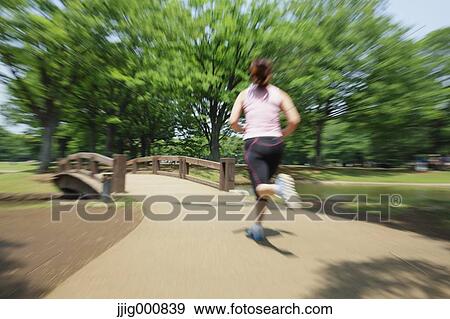 Young Japanese girl running in the park View Large Photo Image Stock Photo - Young Japanese girl running in the park. Fotosearch