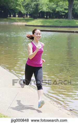 Stock Photo - Young Japanese girl running in the park. Fotosearch