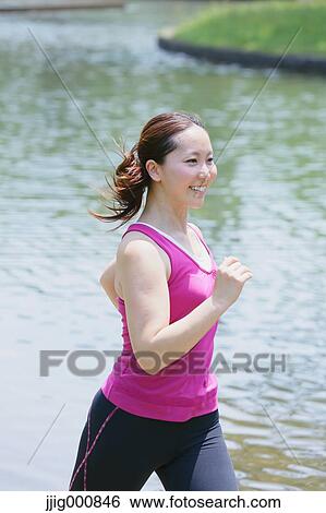 Stock Photograph - Young Japanese girl running in the park. Fotosearch