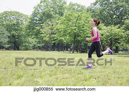 Stock Photography - Young Japanese girl running in the park. Fotosearch