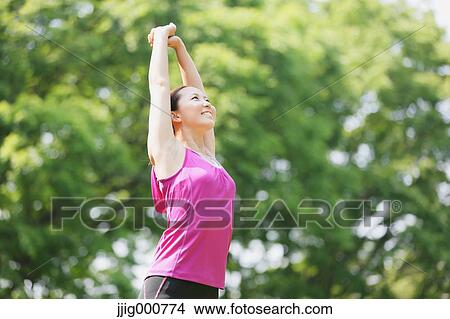 Young Japanese girl stretching in the park View Large Photo Image Picture - Young Japanese girl stretching in the park. Fotosearch