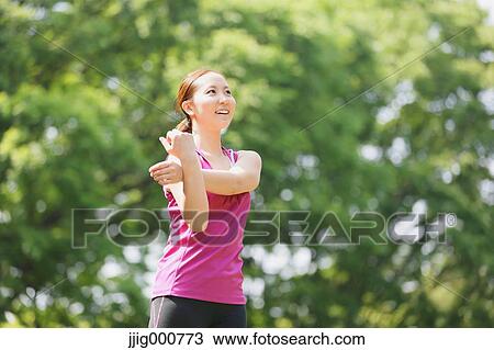 Young Japanese girl stretching in the park View Large Photo Image Stock Image - Young Japanese girl stretching in the park. Fotosearch